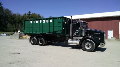 J. A. Simpson, Inc.  Roll-off dumpster being transported